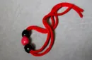 Nana's Necklace (Red) by Dean Dill - Trick – Image 1